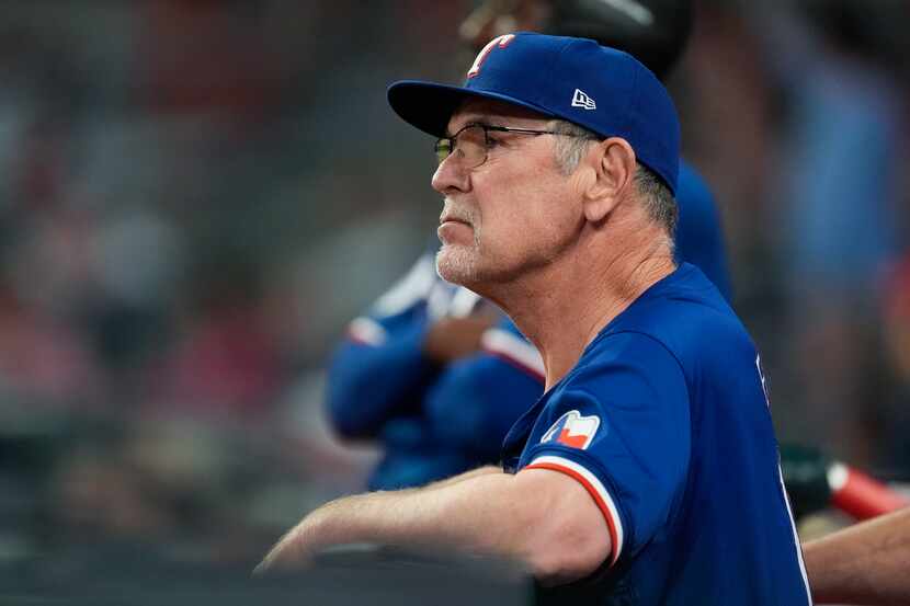 Texas Rangers manager Bruce Bochy looks on from the dugout during a baseball game against...