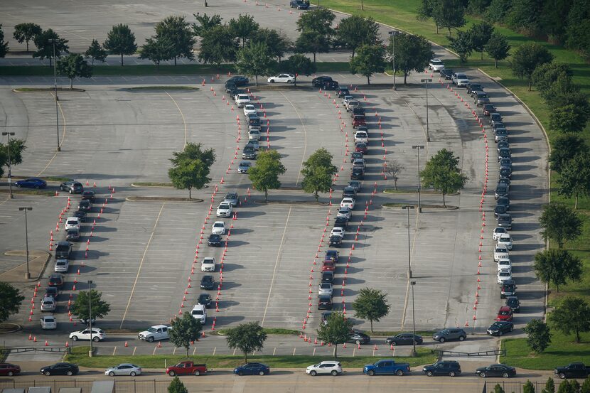 Hundreds of cars weaved around Ellis Davis Field House in the Red Bird area of southern...