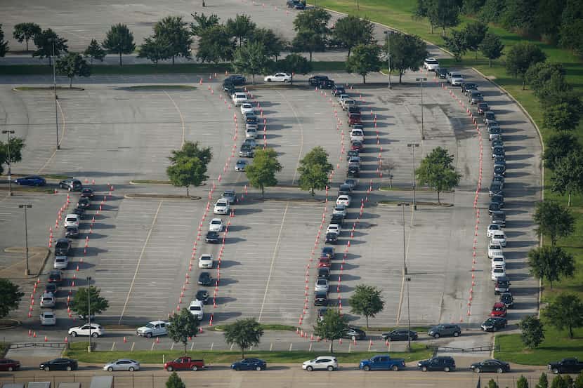 Hundreds of cars weaved around Ellis Davis Field House in the Red Bird area of southern...
