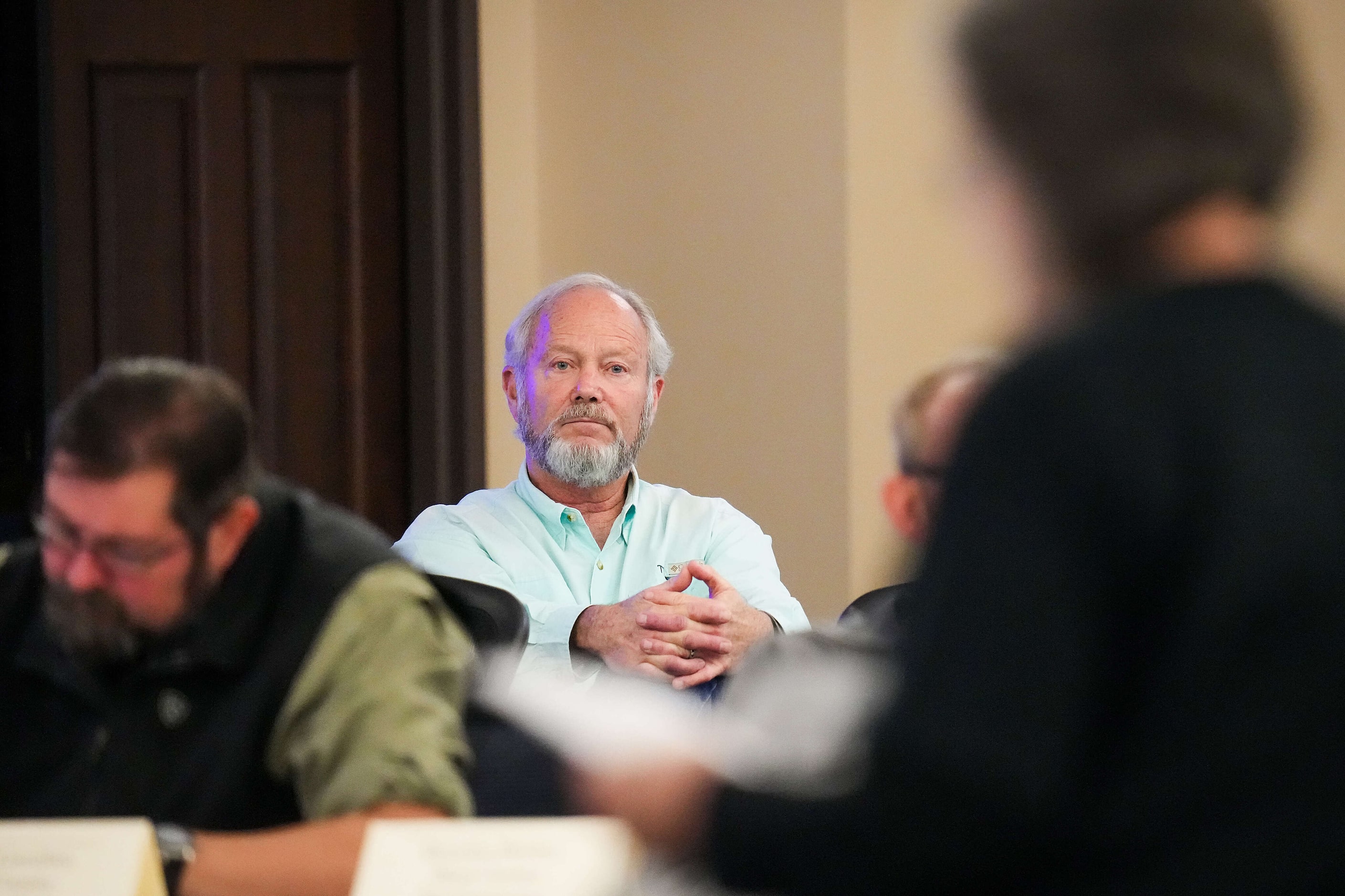 Region C Water Planning Group chair
Kevin Ward listens to a speaker in opposition to the...