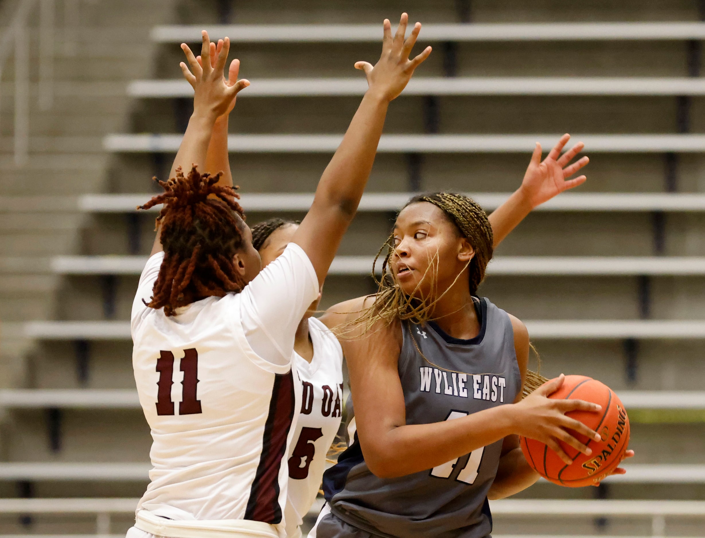 Red Oak players Markeya Mack (11) and Breanna Davis (5) defend Wylie East’s Akasha Davis...