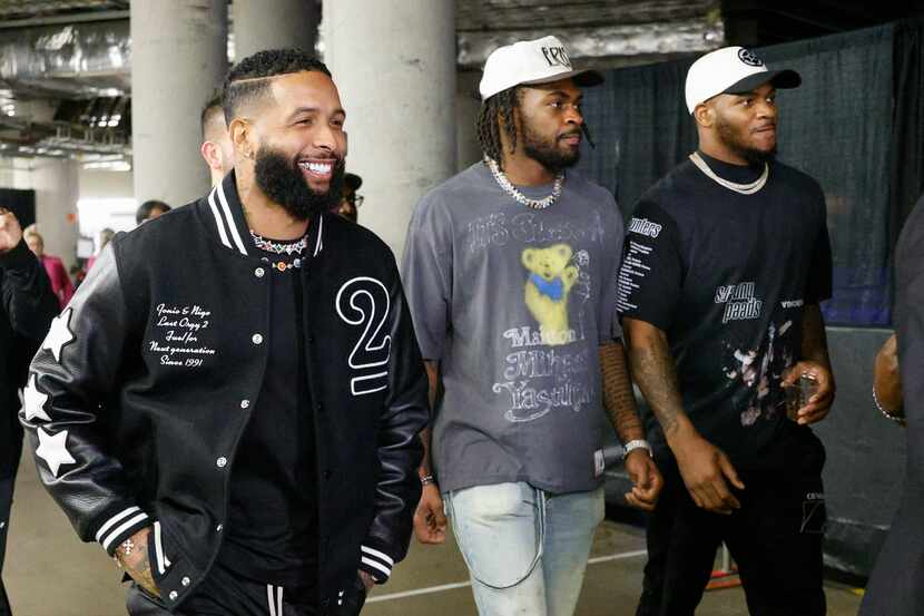 NFL free agent Odell Beckham Jr. (left) walks with Dallas Cowboys players Trevon Diggs...