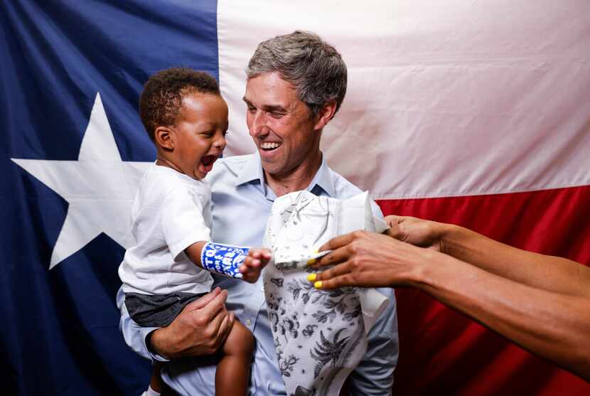 Democratic nominee for Texas governor Beto O'Rourke reacts to Hayden Hammonds, 1, as he...