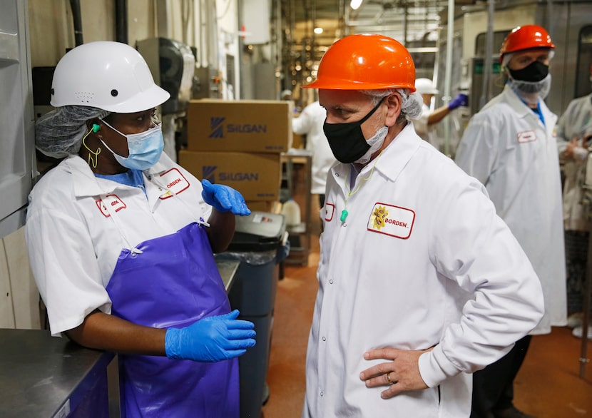 Borden employee Betty Anthony talks with CEO Tony Sarsam in the bottling area at Borden...