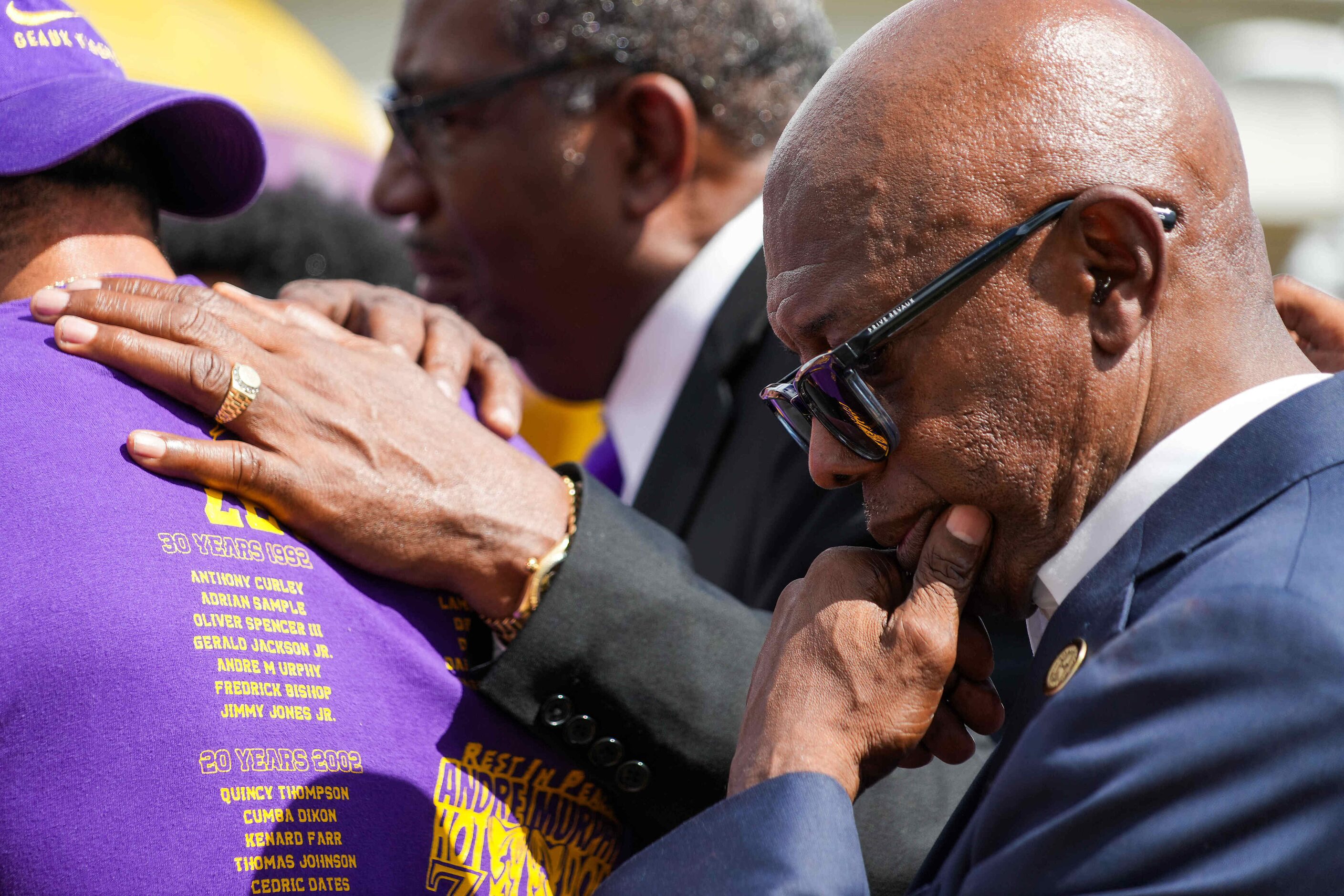 Dallas Mayor Pro Tem Tennell Atkins joins Sen. Royce West (background) as they pray with...