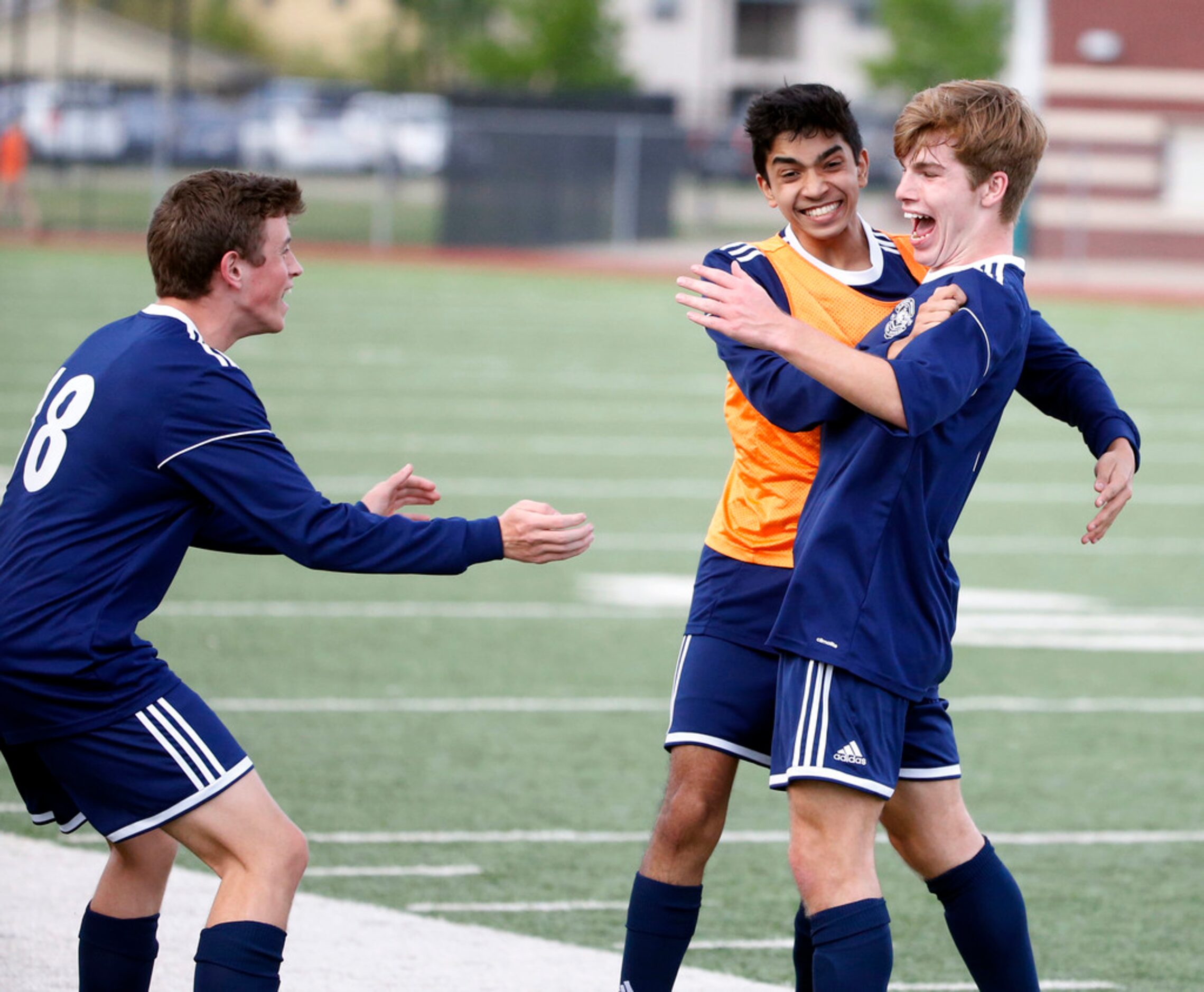 Flower Mound's Shane Popieluch (7), right, is mobbed by Aaditya Patil, center, and Nate...