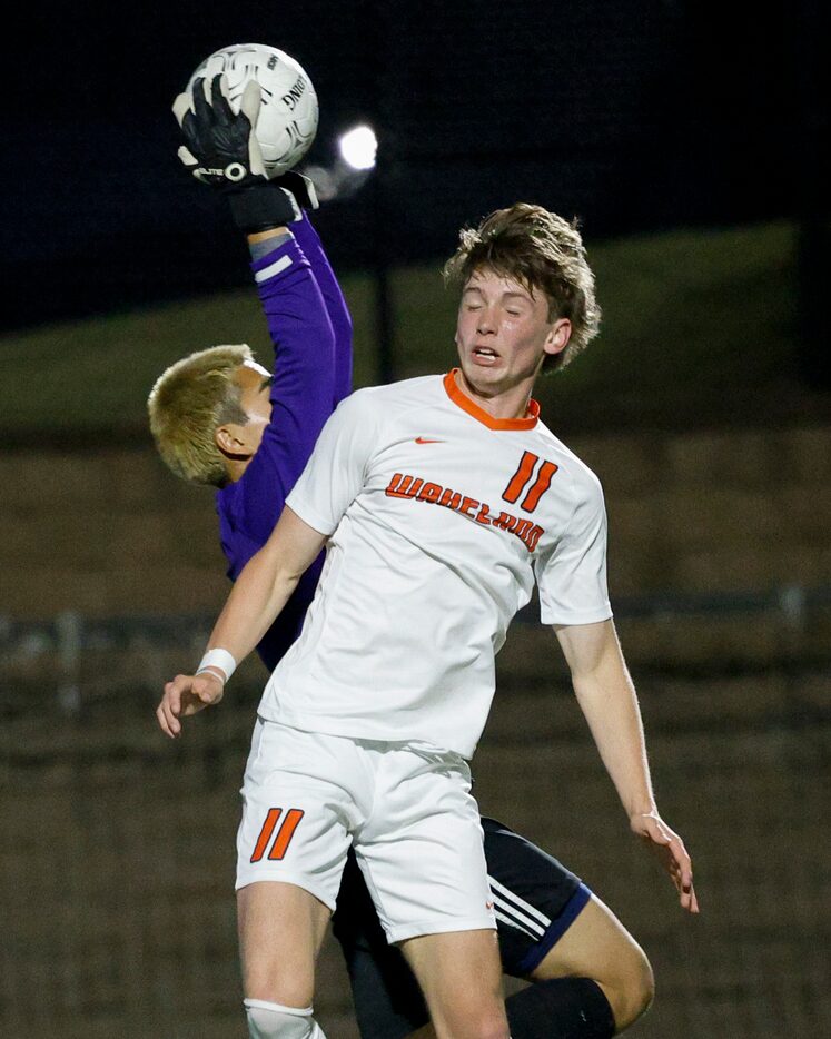 Fort Worth Trimble Tech Goalkeeper Aaron Ceja (1) catches the ball over Frisco Wakeland...