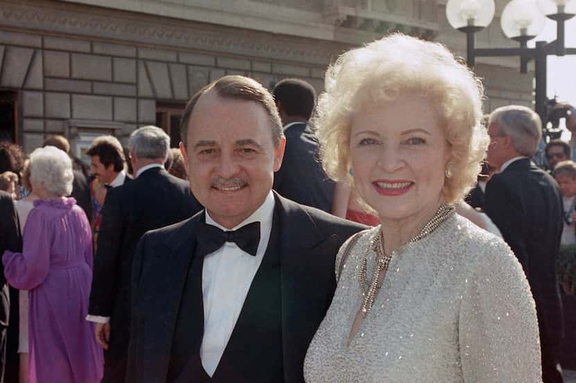 ohn Hillerman, left, and Betty White arrive at the Emmy Awards in Pasadena, Calif....