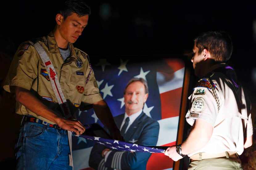 Boy Scouts Brandon Wawzysko, left, and Seth Fisher retire the American flag during a...