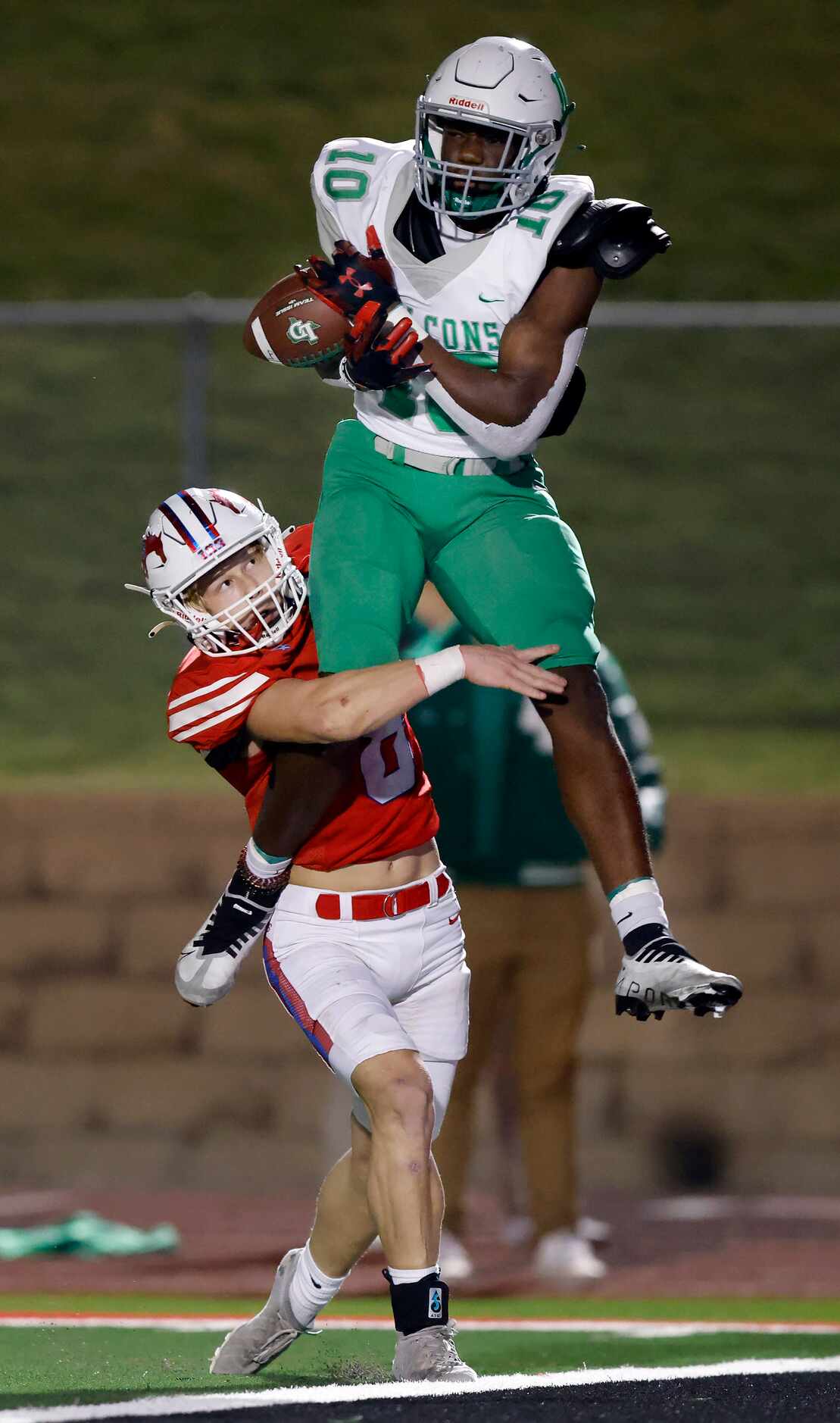 Lake Dallas receiver Keonde Henry (10) tries to corral a pass at the goal line as he’s hit...