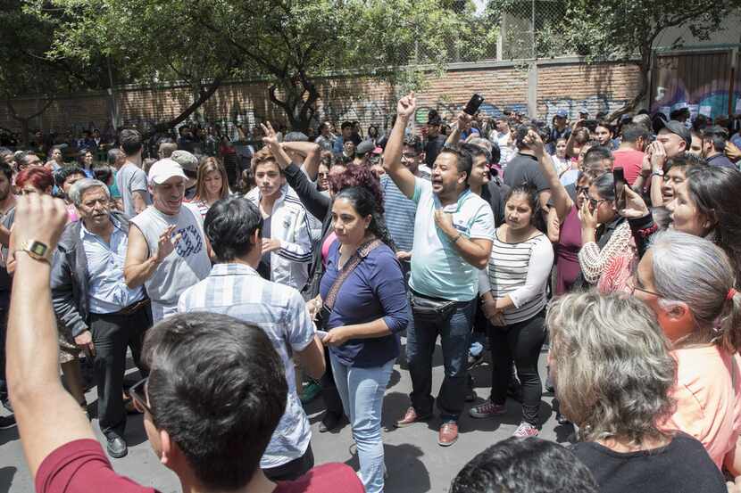 People in Mexico City react to the lack of ballots in the polling station on July 1, 2018 in...