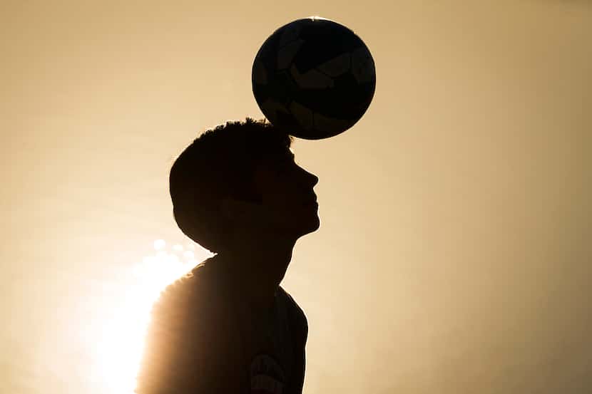 Dallas Morning News file photo, 2015: Nicolas Reyes, 13, heads a soccer ball at a park near...
