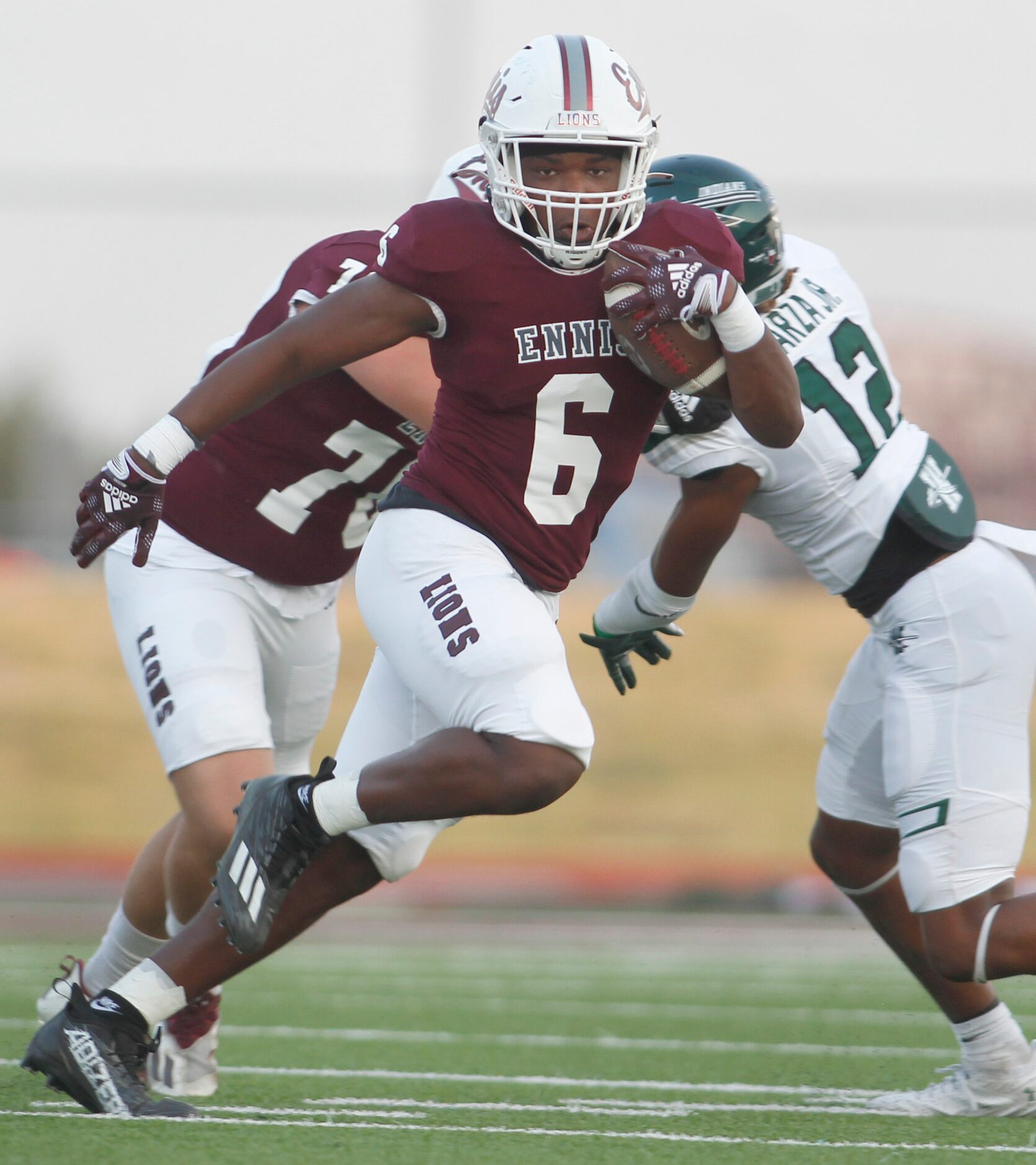 Ennis running back Jamarion Wafford (6) breaks into the Waxahachie secondary during a first...