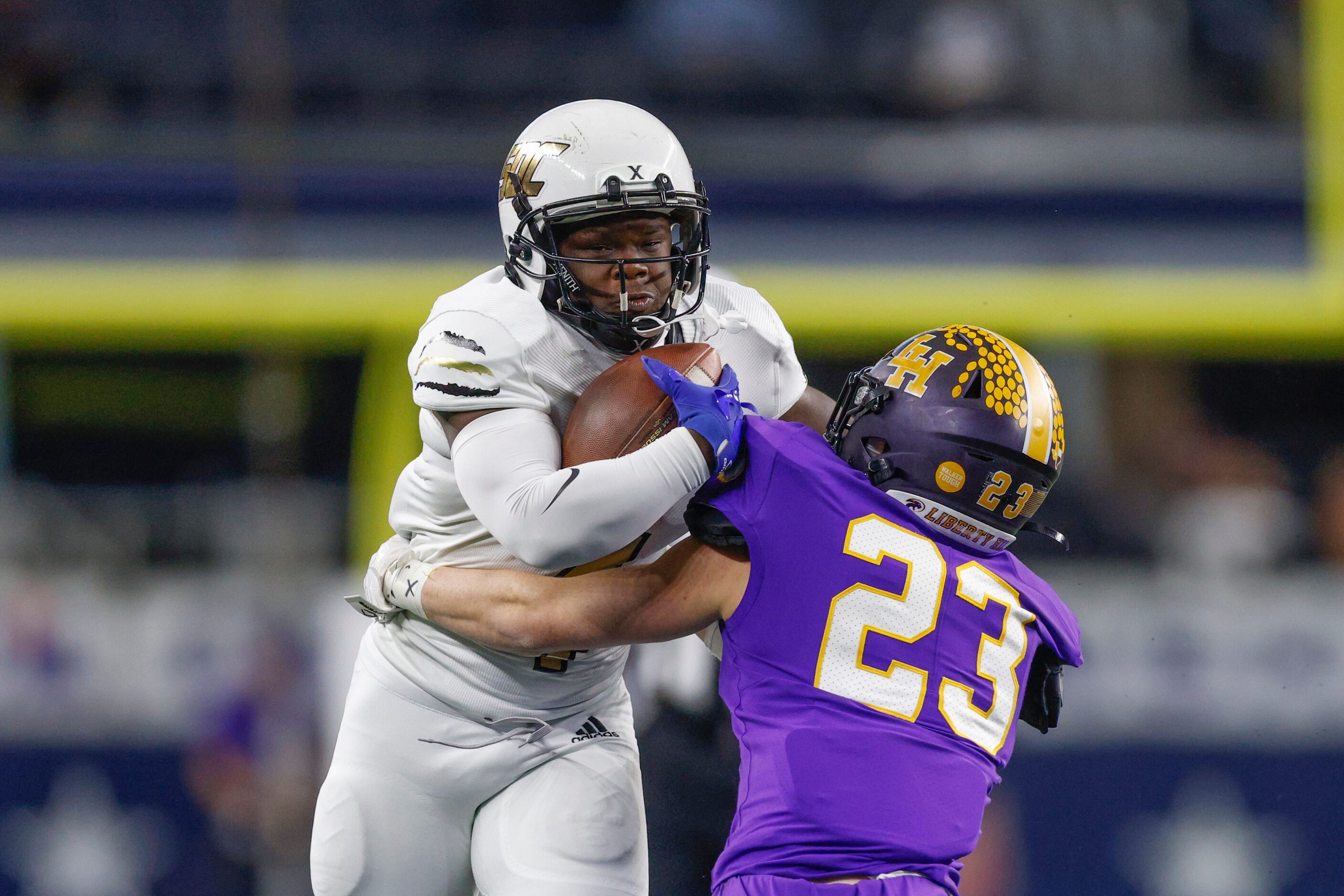 Liberty Hill defensive back Carlton Schrank (23) tackles South Oak Cliff running back Qualon...