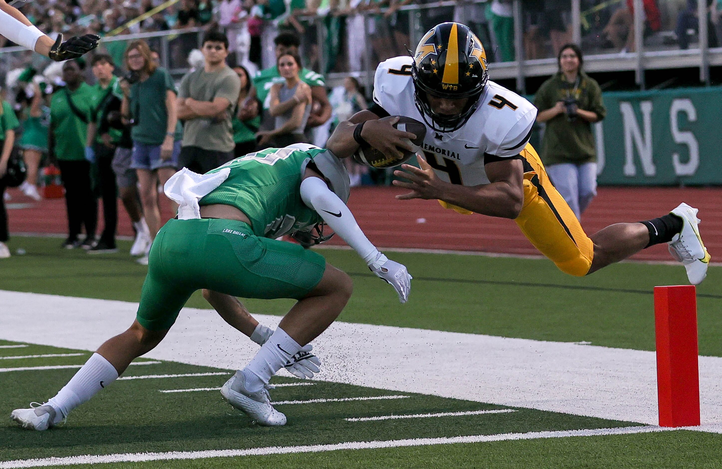 Frisco Memorial quarterback Damarion McPherson (4) is a little short of the goal line as he...