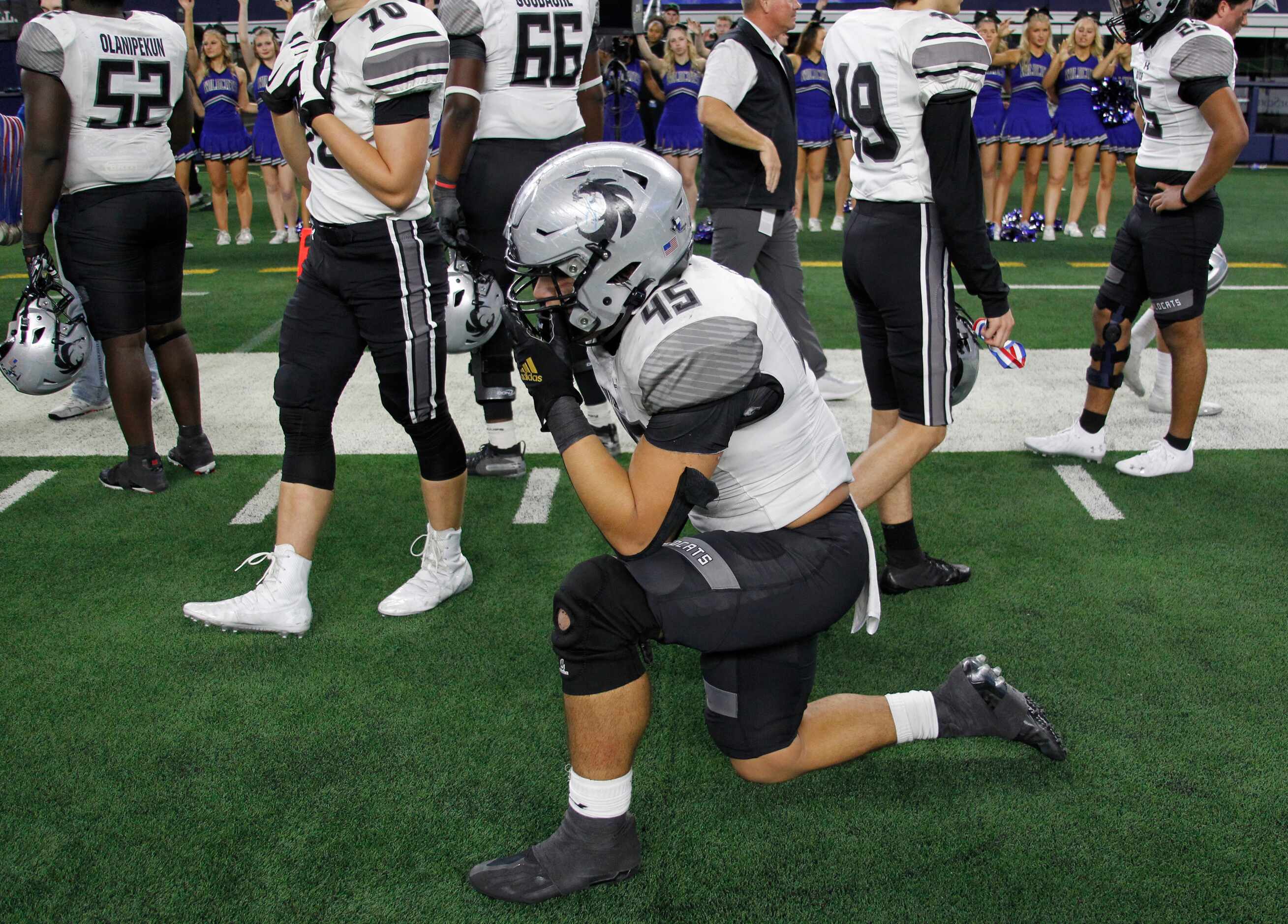 Denton Guyer's Ivan Pena (45) takes a knee on the team sidelines following their 40-21 loss...