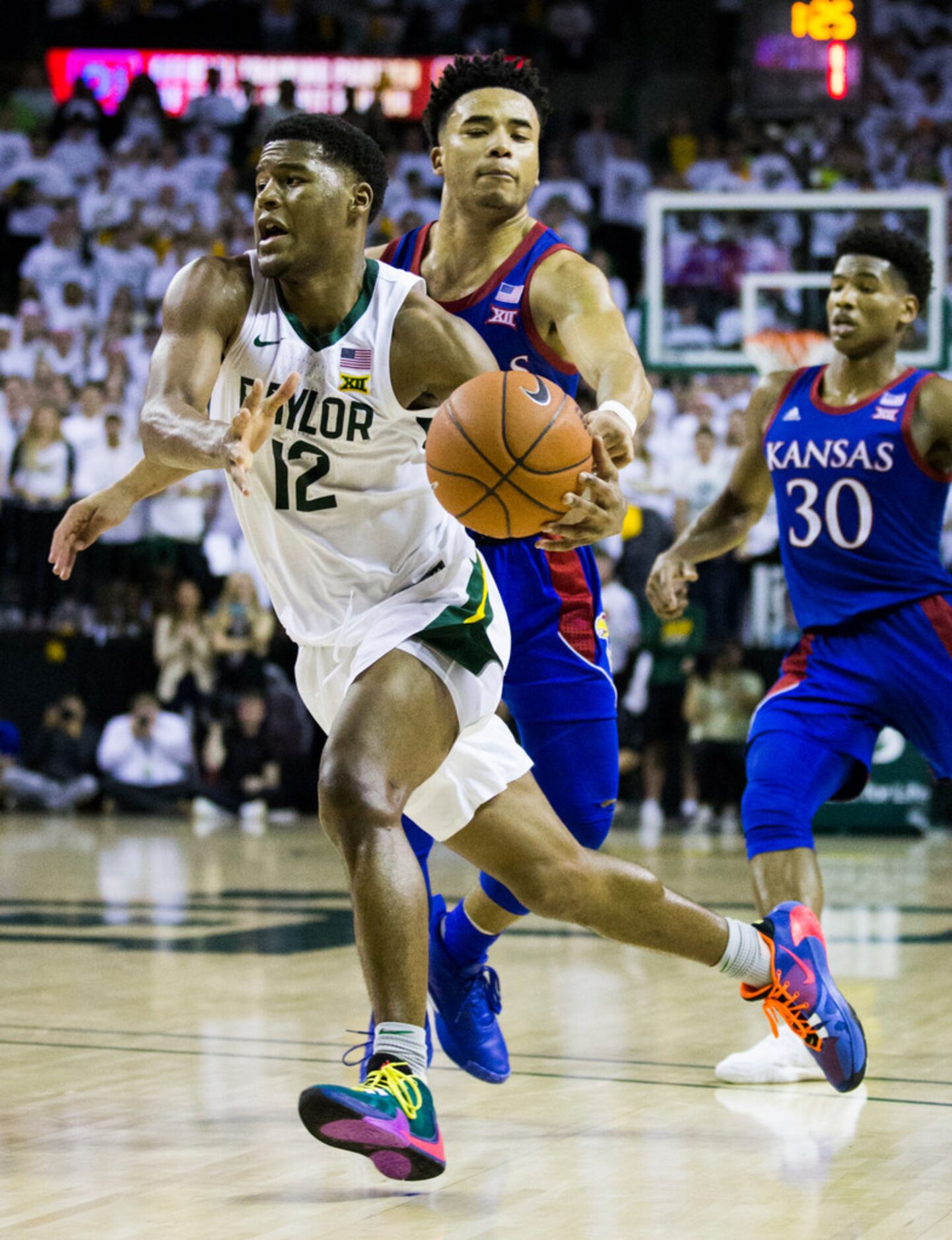 Baylor Bears guard Jared Butler (12) gets past Kansas Jayhawks guard Devon Dotson (1) during...