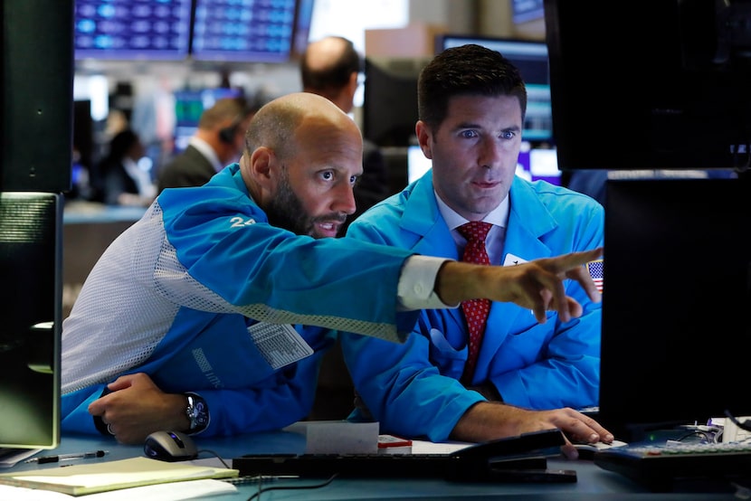 Specialists Meric Greenbaum (left) and Thomas McArdle work on the floor of the New York...