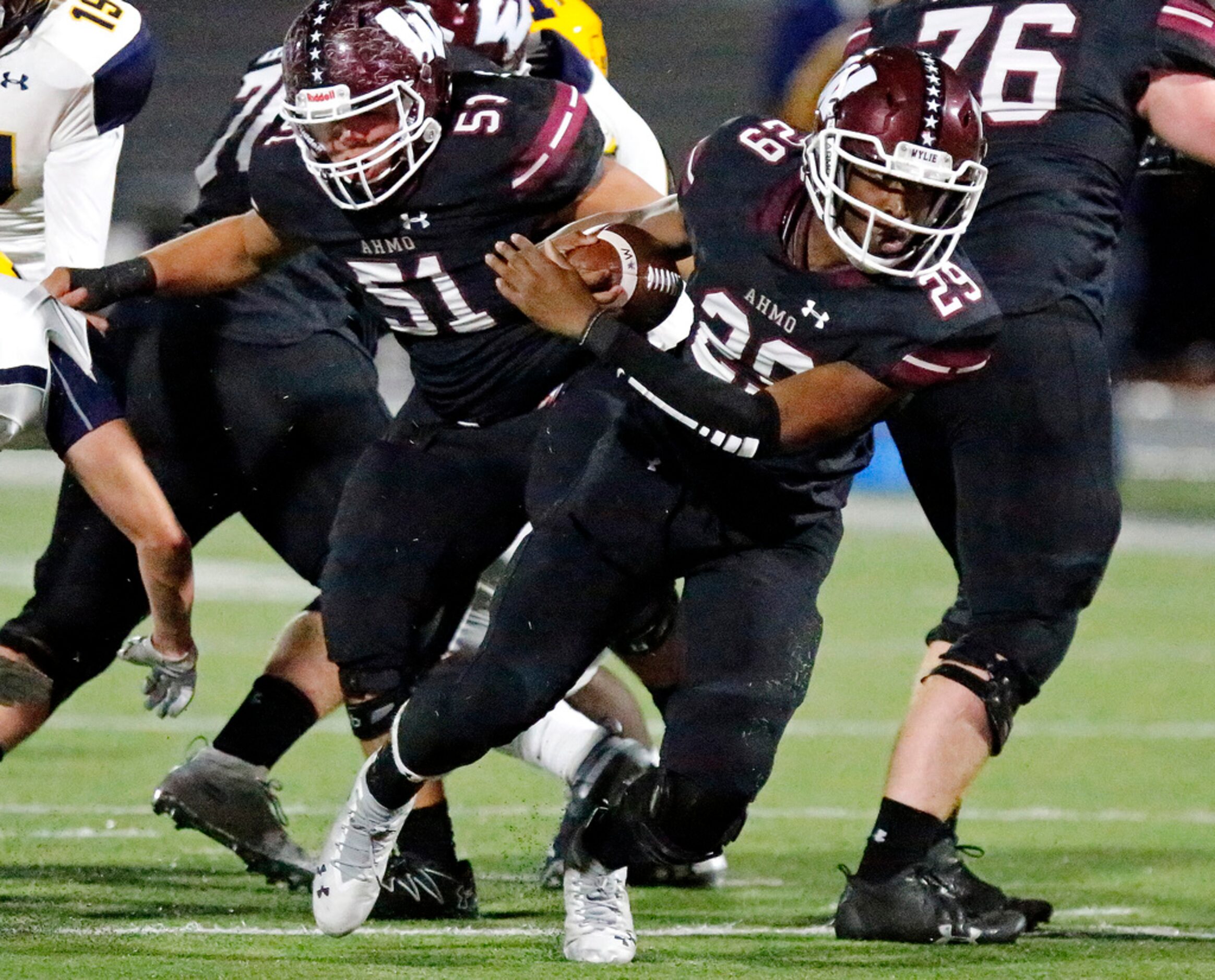 Wylie High School running back Trelon Sheffield (29) breaks through the line for extra...