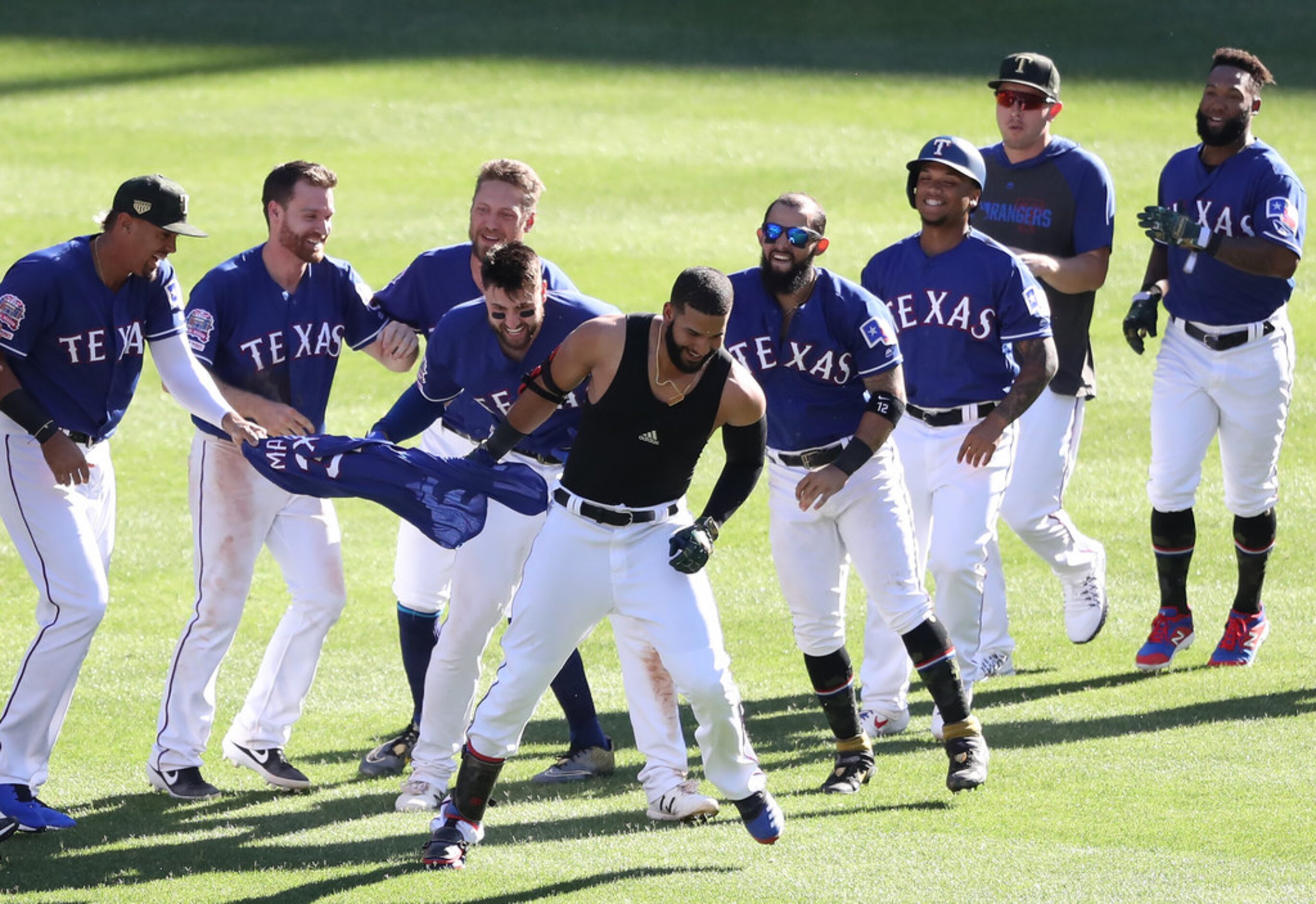 ARLINGTON, TEXAS - MAY 19:  The Texas Rangers celebrate the game winning run scored on a...