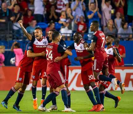 FC Dallas forward Tesho Akindele hugs defender Matt Hedges (24) while celebrating with...