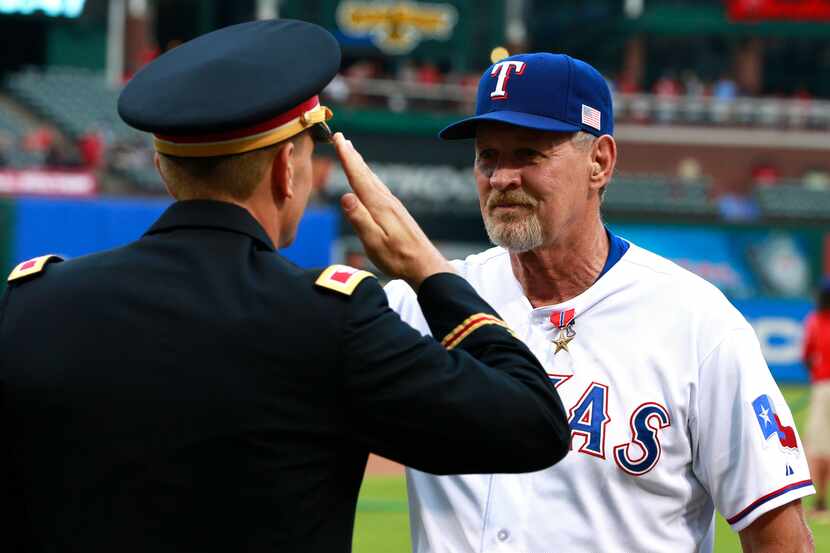 Sep 11, 2014; Arlington, TX, USA; Texas Rangers bench coach Bobby Jones (5) saluted by Col....