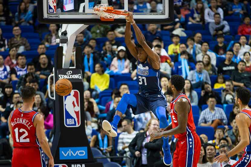 Dallas Mavericks forward Kostas Antetokounmpo (37) dunks the ball past Philadelphia 76ers...