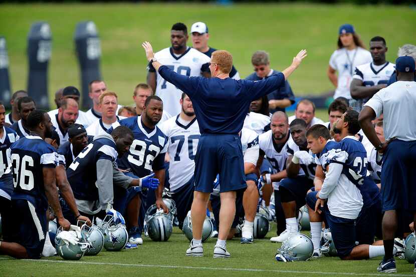 Dallas Cowboys head coach Jason Garrett huddles up his players at the end of OTA practice at...