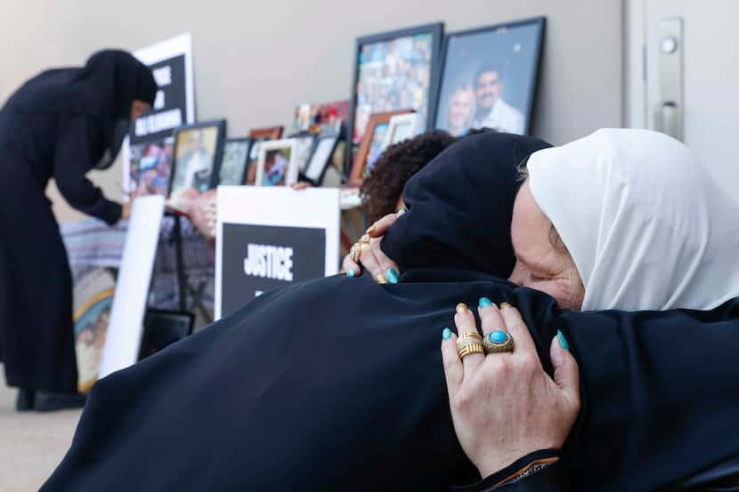 Fatema Mohammed Hadi, left, embraces Stephanie Young Elbanna, the widow of Ali Elbanna, at...