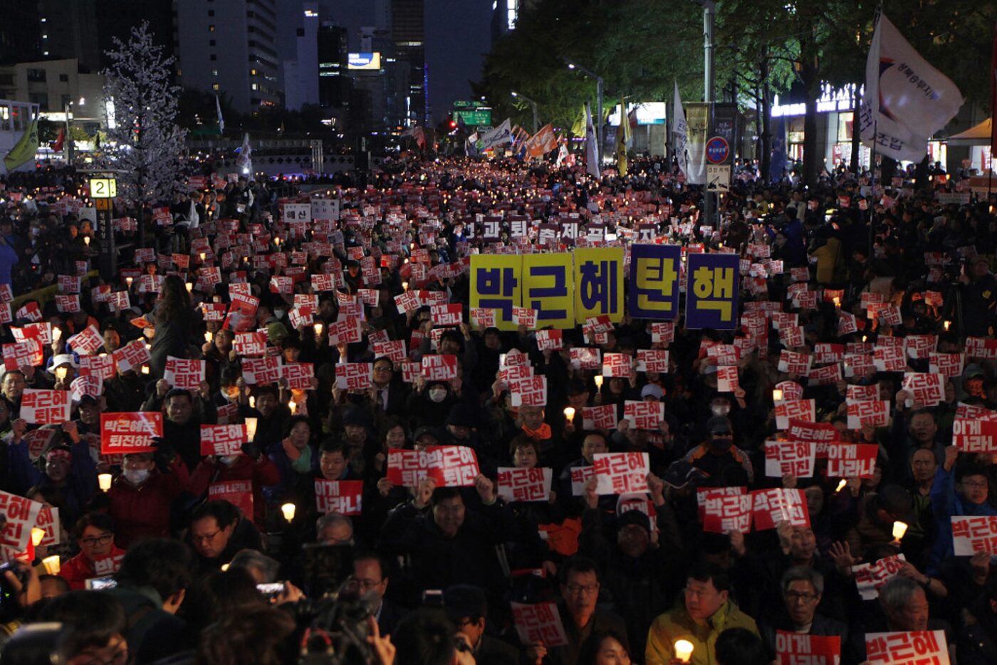 Thousands of South Koreans took to the streets in the city center to demand that President...