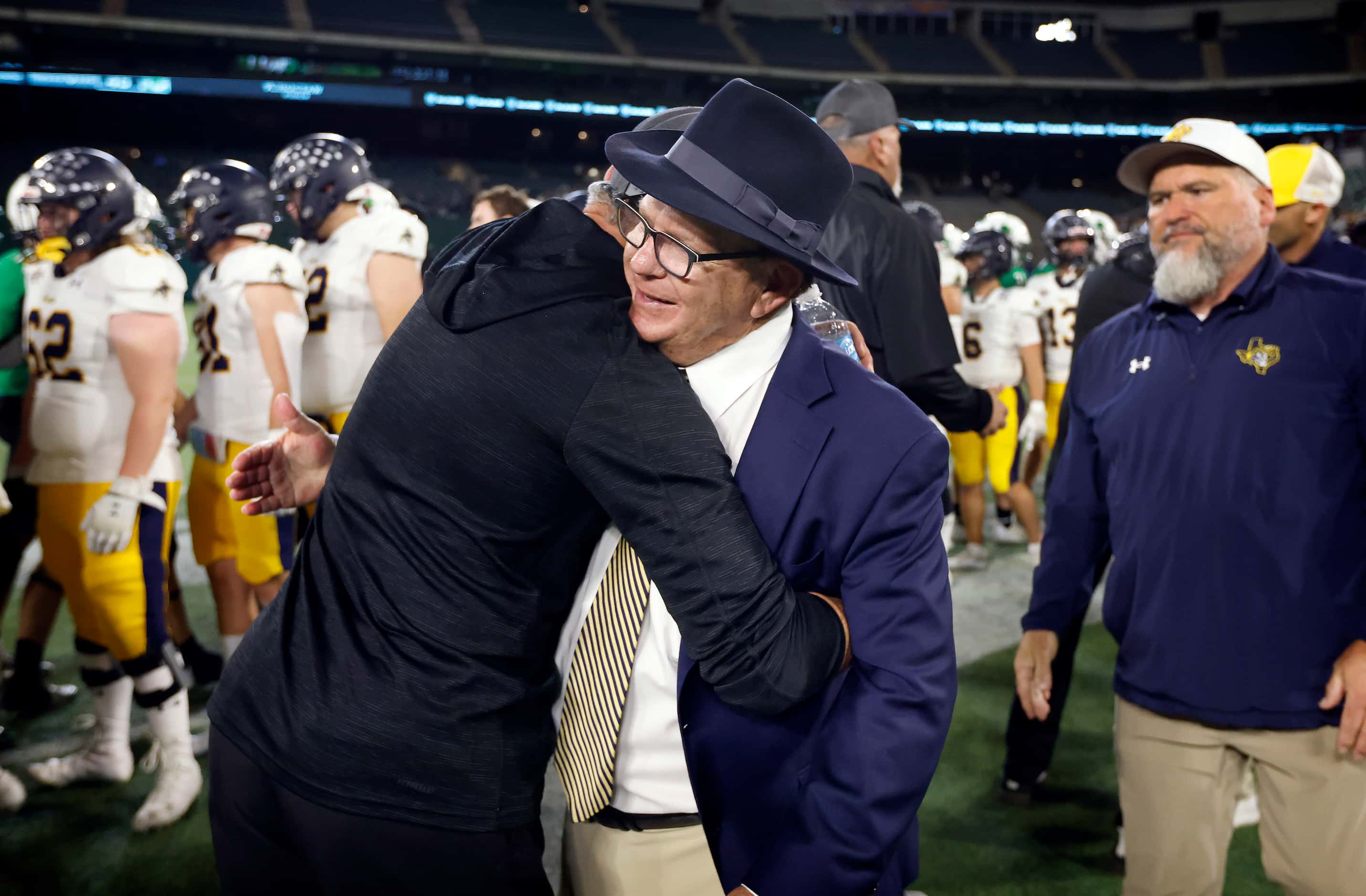 Legendary Highland Park head football coach Randy Allen receives hugs from the Southlake...