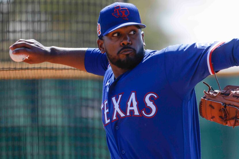 Texas Rangers pitcher Kumar Rocker throws a pitch for batting practice during a spring...