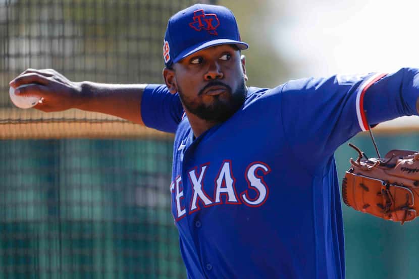 Texas Rangers pitcher Kumar Rocker throws a pitch for batting practice during a spring...