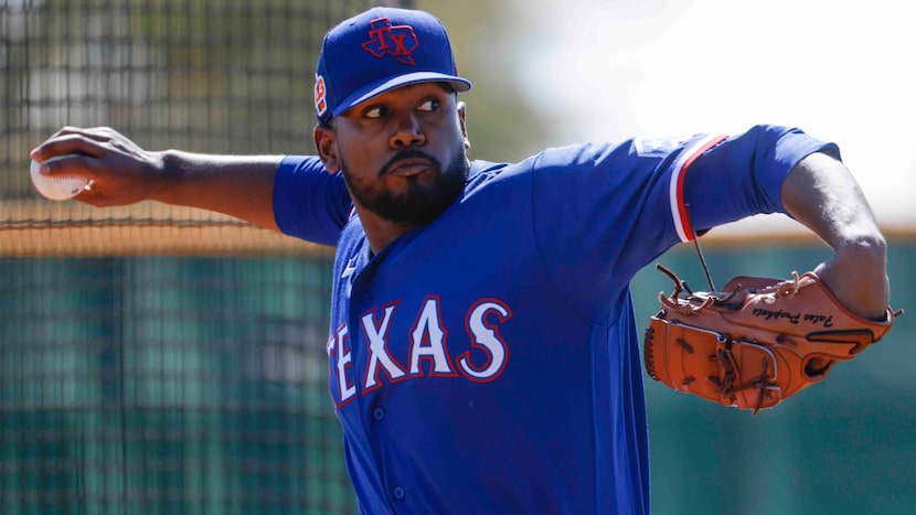 Texas Rangers pitcher Kumar Rocker throws a pitch for batting practice during a spring...