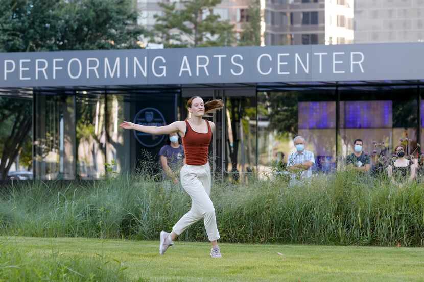 Dancer Taylor Kinsey moves along the grass during a performance of “The Great 30" outside...