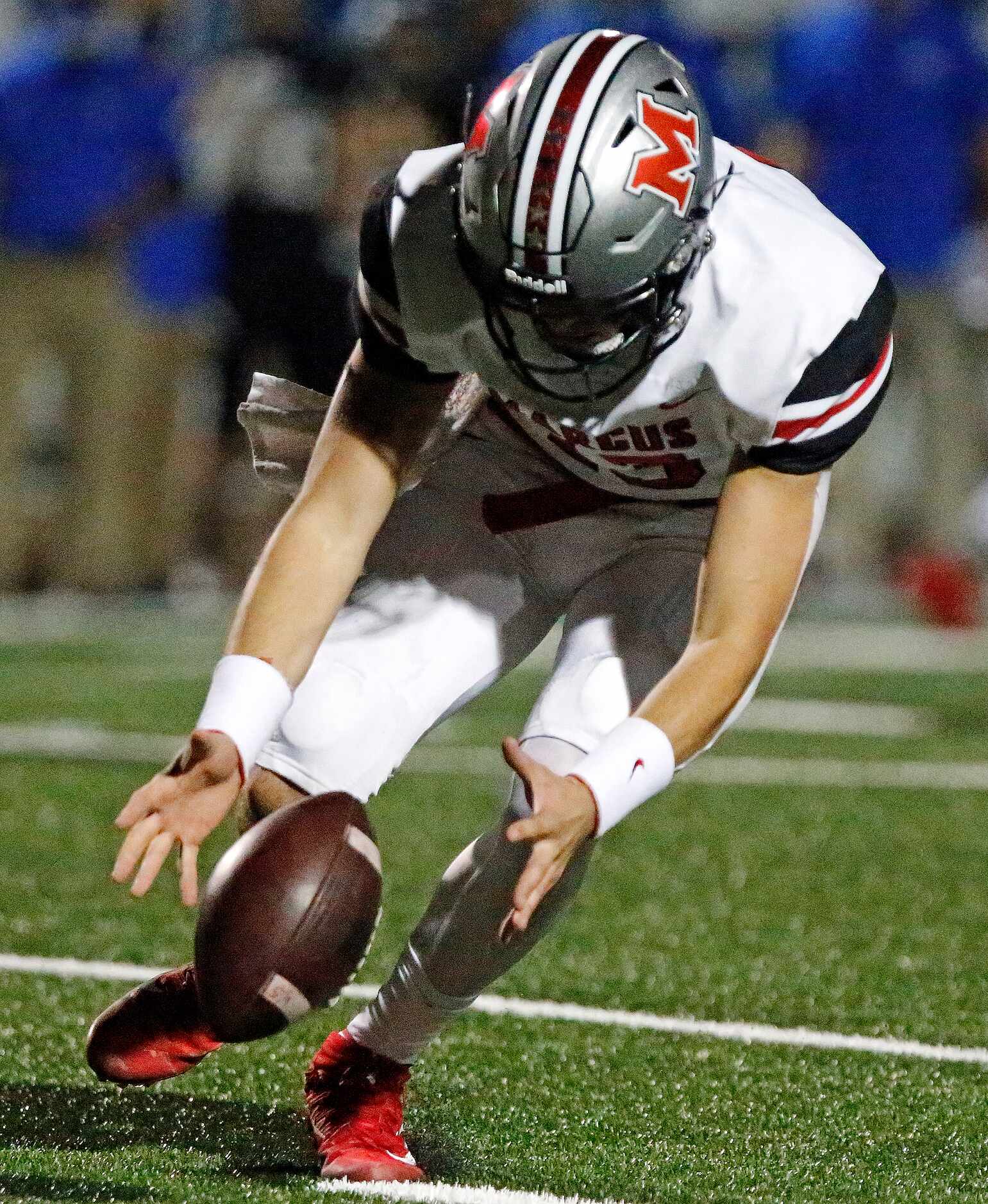 Flower Mound Marcus High School quarterback Garrett Nussmeier (13) picks up and errant snap...