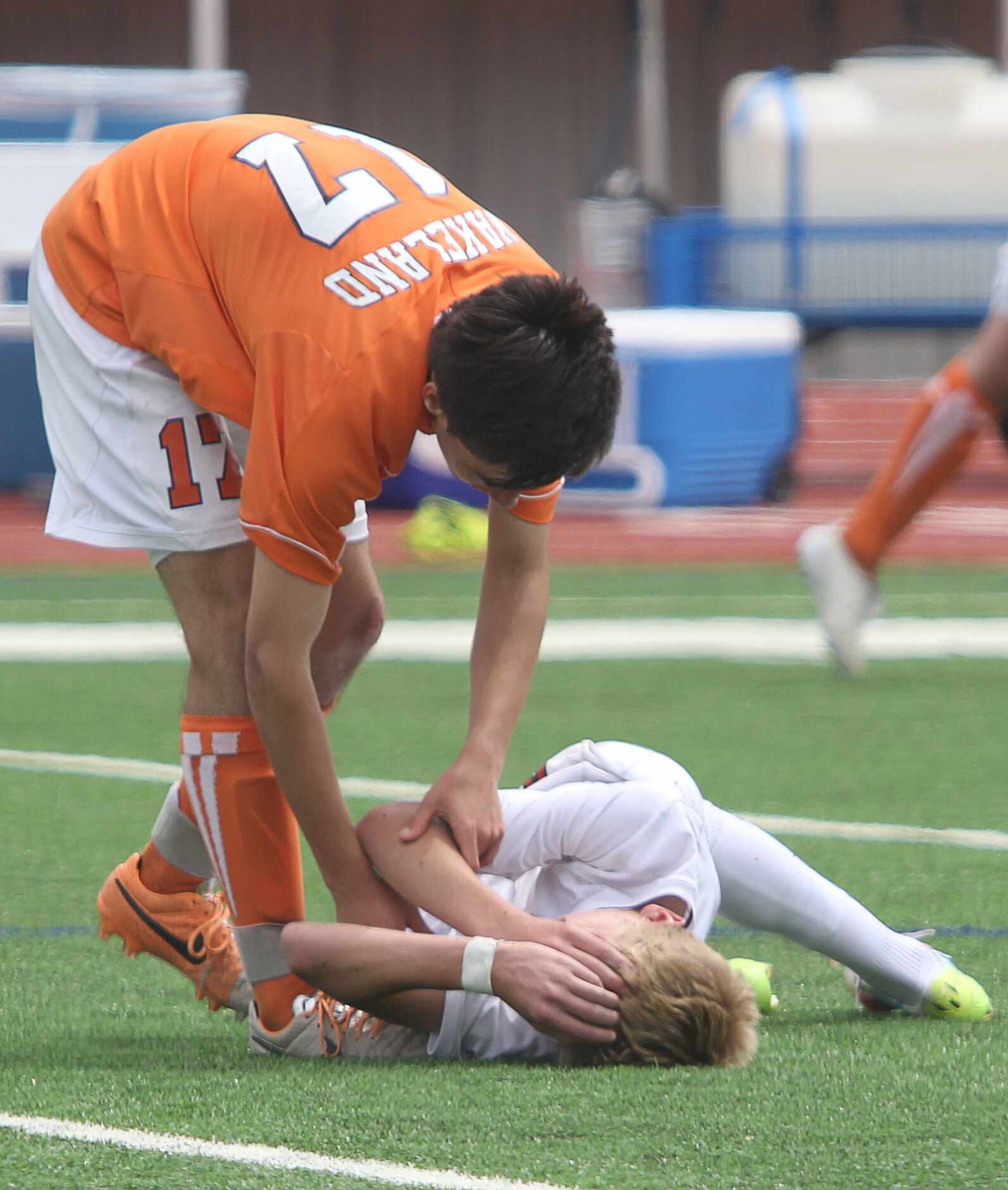 Frisco Wakeland's Logan Biggs (17) tries to console Frisco Liberty's Keaton Parks (4, laying...
