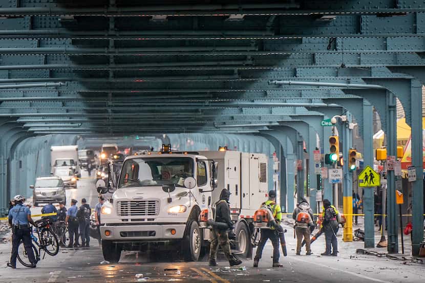 Police and sanitation workers clear an encampment on Kensington Ave., in Philadelphia,...