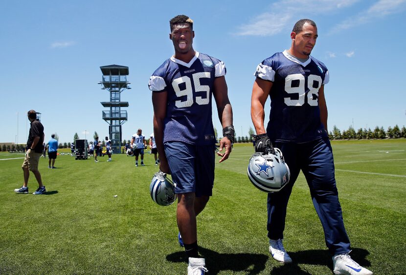 Dallas Cowboys defensive tackle David Irving (95) sticks his tongue out as he and defensive...