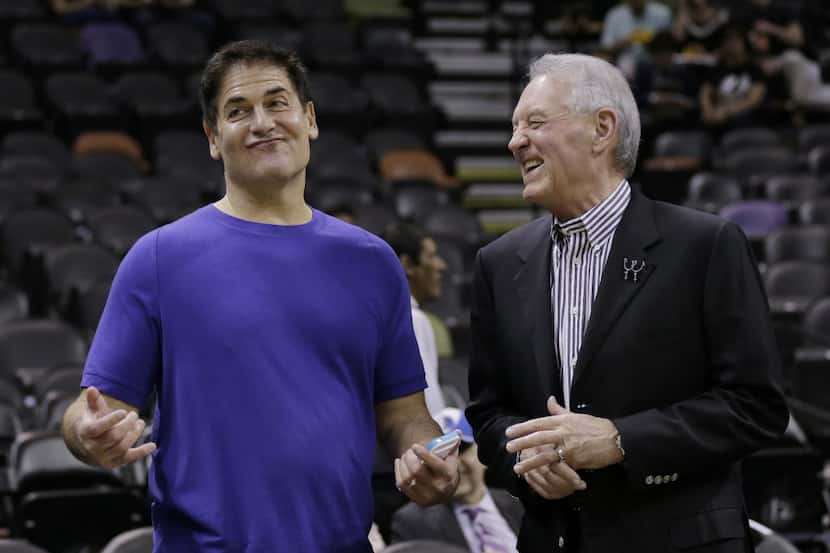Dallas Mavericks owner Mark Cuban, left, and San Antonio Spurs owner Peter Holt, right,...
