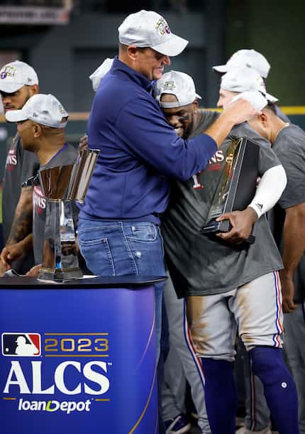 Texas Rangers general manager Chris Young hugs his Most Valuable Player Adolis Garcia after...