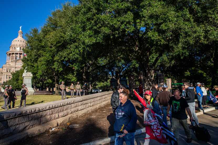 Texas State troopers stand guard as supporters of President Donald Trump protest outside the...