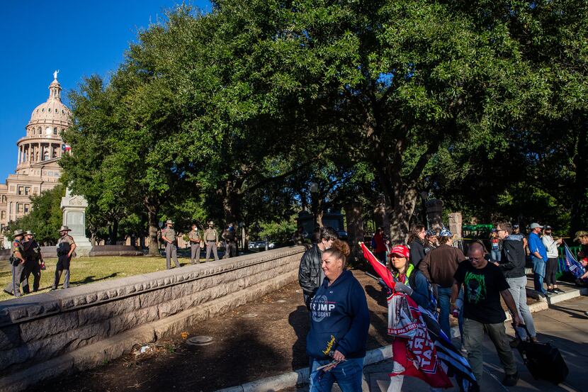Texas State troopers stand guard as supporters of President Donald Trump protest outside the...