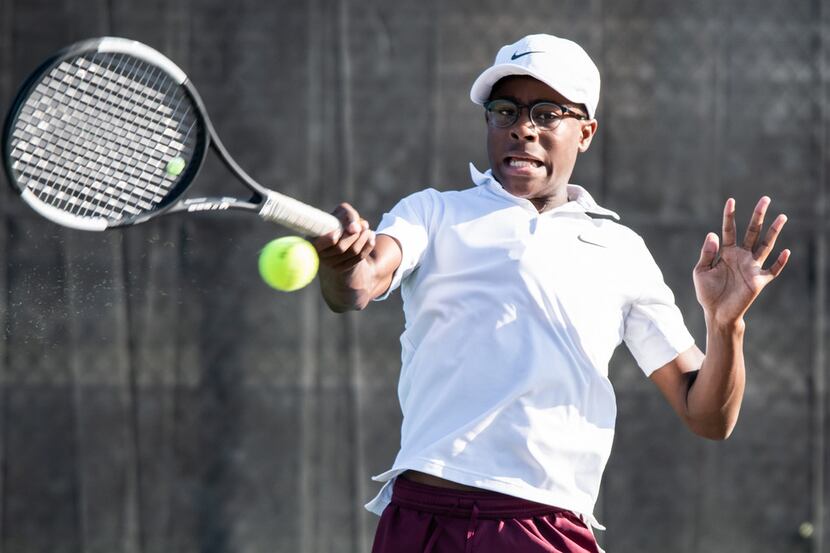 Red Oak's Jered Wilson returns the ball in a singles match against Northside Harlan's Landon...