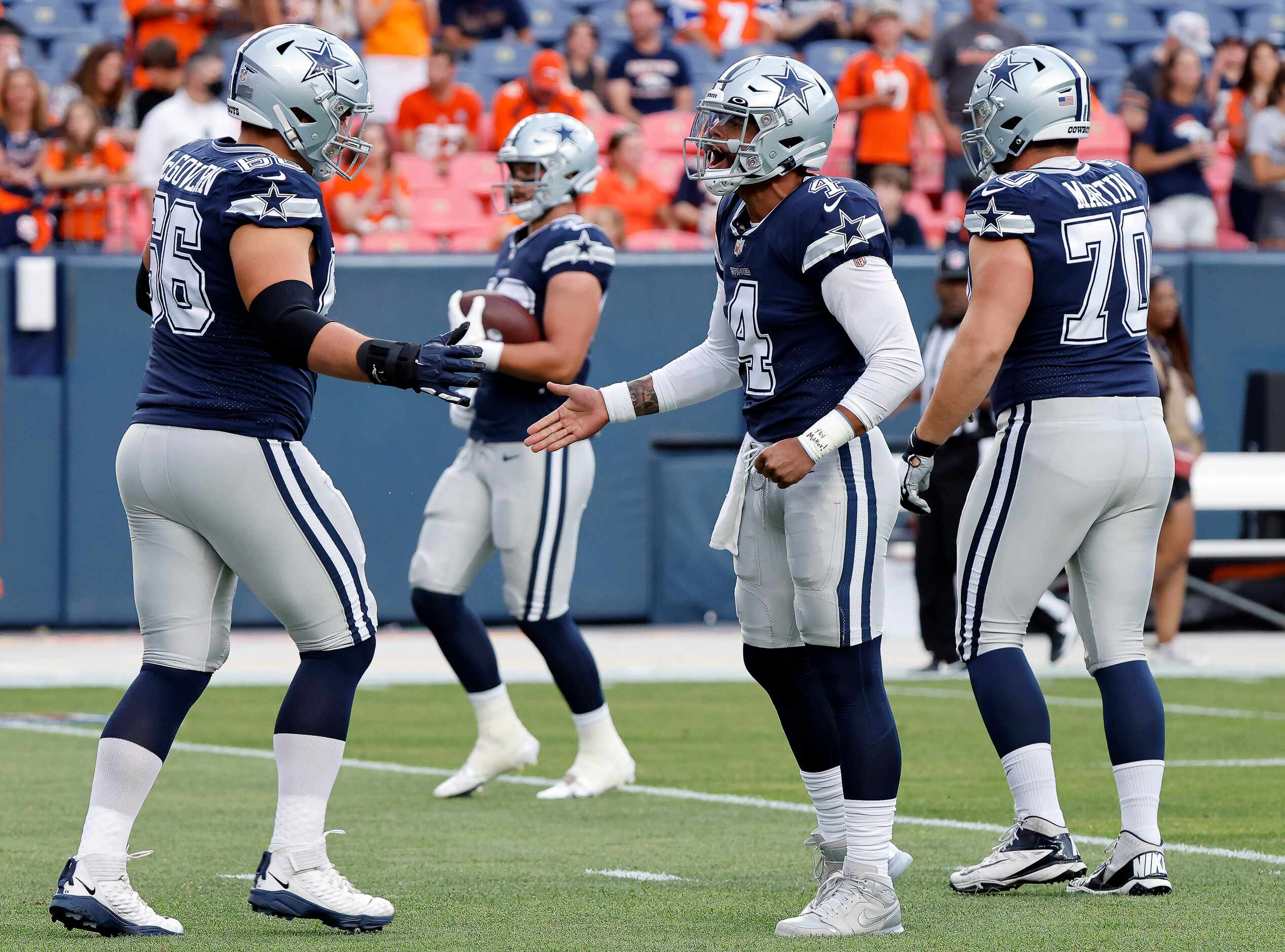 Dallas Cowboys quarterback Dak Prescott (4) greets guard Connor McGovern (66) before their...