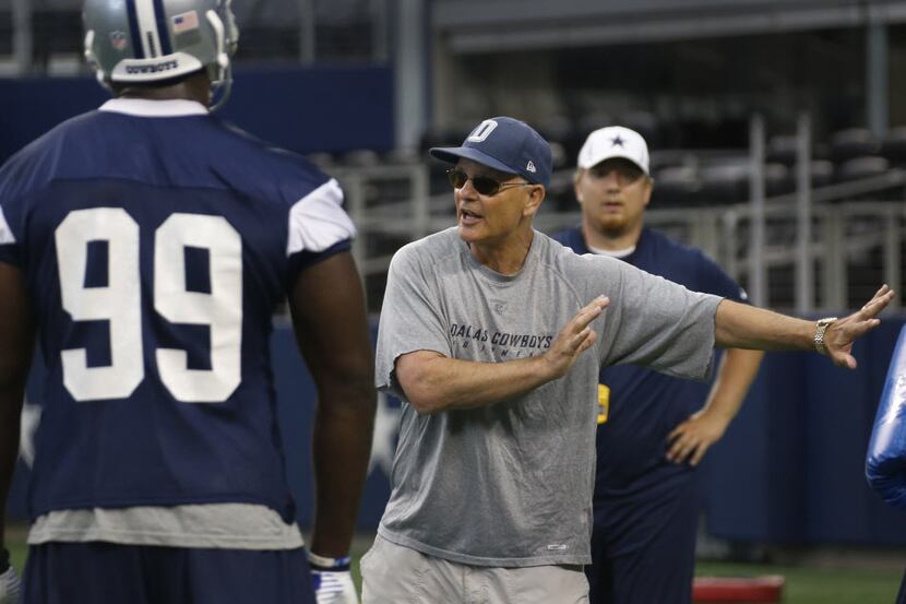 Cowboys defensive coach Rod Marinelli works with defensive end George Selvie (99) during...