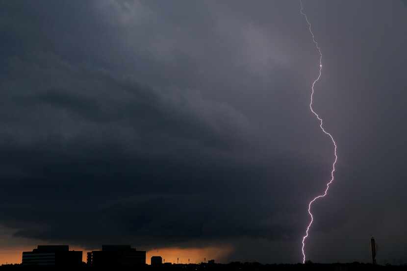 A lightning bolt from a thunderstorm strikes down in Irving, Texas, Thursday, June 7, 2018. 
