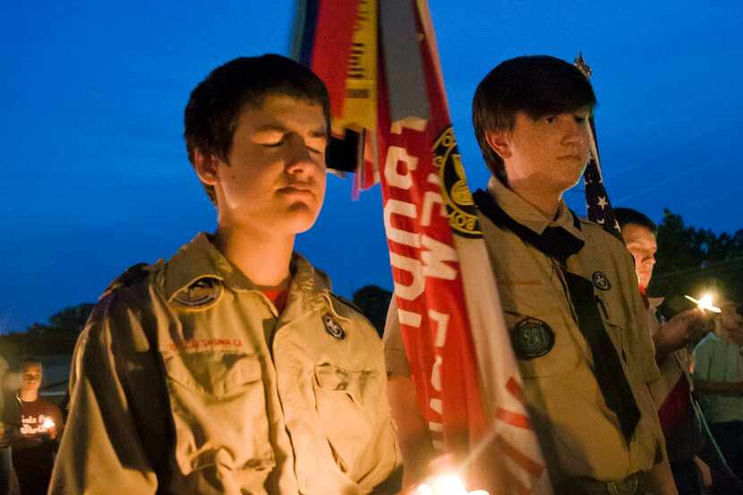 Ian Sullens, of Troop 621, left, and Samuel Powers of Troop 201 participate in a candlelight...