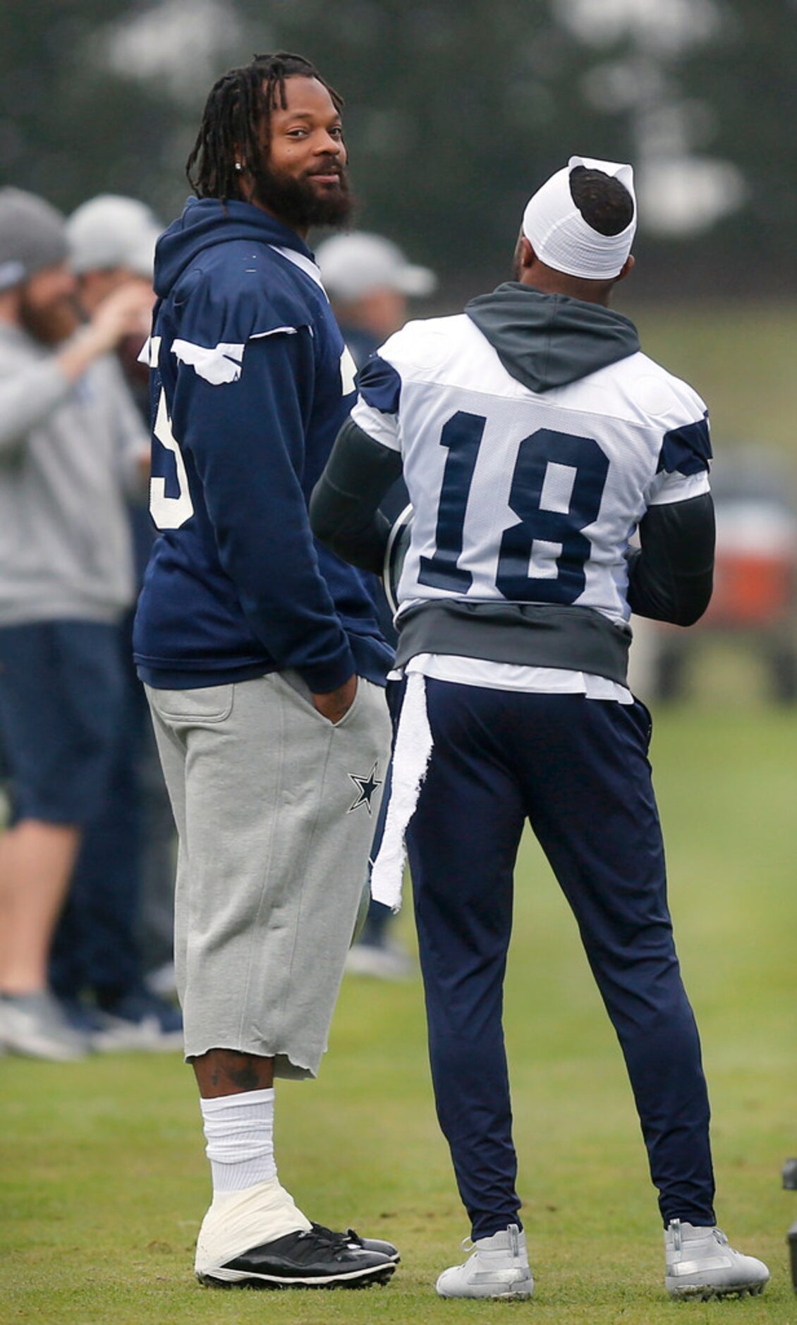 New Dallas Cowboys defensive end Michael Bennett Jr. (79) visits with wide receiver Randall...