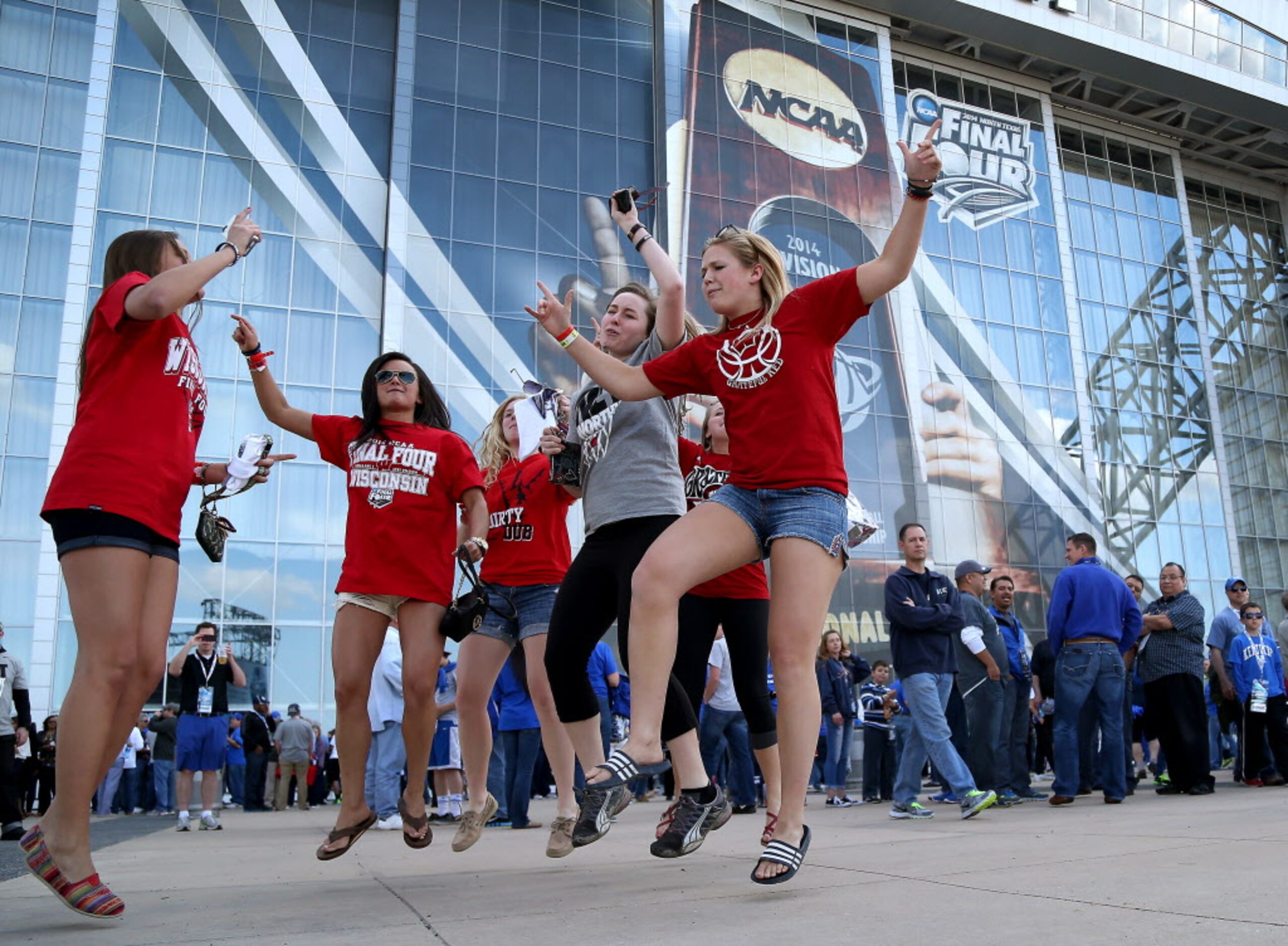 Wisconsin fans dance together in the Tip-Off Tailgate presented by Infiniti area on the east...